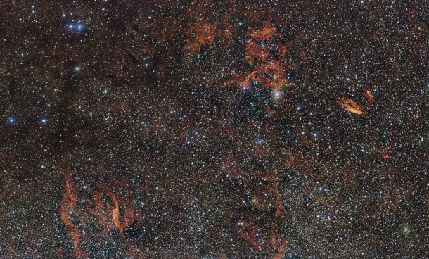 this huge image of part of the southern constellation of Norma (The Carpenter’s Square) wisps of crimson gas are illuminated by rare, massive stars that have only recently ignited and are still buried deep in thick dust clouds. These scorching-hot, very young stars are only fleeting characters on the cosmic stage and their origins remain mysterious. The vast nebula where these giants were born, known as RCW 106, is captured here in fine detail by ESO’s VLT Survey Telescope (VST), at the Paranal Observatory in Chile. The brightest part appears just above the centre of the image. Credit: ESO this huge image of part of the southern constellation of Norma (The Carpenter’s Square) wisps of crimson gas are illuminated by rare, massive stars that have only recently ignited and are still buried deep in thick dust clouds. These scorching-hot, very young stars are only fleeting characters on the cosmic stage and their origins remain mysterious. The vast nebula where these giants were born, known as RCW 106, is captured here in fine detail by ESO’s VLT Survey Telescope (VST), at the Paranal Observatory in Chile. The brightest part appears just above the centre of the image. Credit: ESO