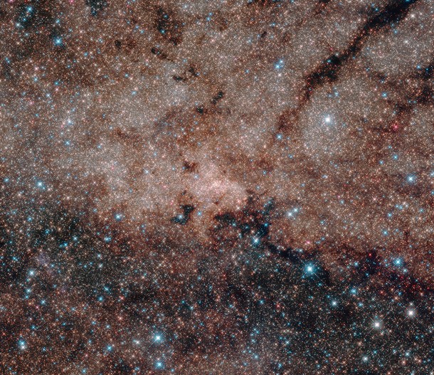 Hubble's infrared vision pierced the dusty heart of our Milky Way galaxy to reveal more than half a million stars at its core. At the very hub of our galaxy, this star cluster surrounds the Milky Way's central supermassive black hole, which is about 4 million times the mass of our sun. Credits: NASA, ESA, and Hubble Heritage Team (STScI/AURA, Acknowledgment: T. Do, A.Ghez (UCLA), V. Bajaj (STScI) Hubble's infrared vision pierced the dusty heart of our Milky Way galaxy to reveal more than half a million stars at its core. At the very hub of our galaxy, this star cluster surrounds the Milky Way's central supermassive black hole, which is about 4 million times the mass of our sun. Credits: NASA, ESA, and Hubble Heritage Team (STScI/AURA, Acknowledgment: T. Do, A.Ghez (UCLA), V. Bajaj (STScI)
