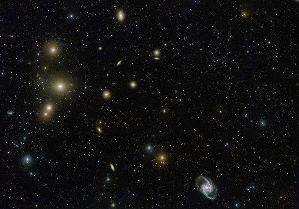 The Fornax Galaxy Cluster is one of the closest of such groupings beyond our Local Group of galaxies. This new VLT Survey Telescope image shows the central part of the cluster in great detail. At the lower-right is the elegant barred-spiral galaxy NGC 1365 and to the left the big elliptical NGC 1399. Credit: ESO. Acknowledgement: Aniello Grado and Luca Limatola The Fornax Galaxy Cluster is one of the closest of such groupings beyond our Local Group of galaxies. This new VLT Survey Telescope image shows the central part of the cluster in great detail. At the lower-right is the elegant barred-spiral galaxy NGC 1365 and to the left the big elliptical NGC 1399. Credit: ESO. Acknowledgement: Aniello Grado and Luca Limatola
