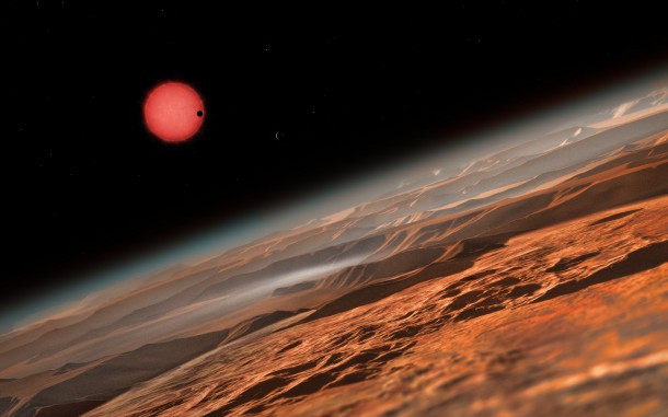 In this view one of the inner planets is seen in transit across the disc of its tiny and dim parent star. Credit: ESO/M. Kornmesser In this view one of the inner planets is seen in transit across the disc of its tiny and dim parent star. Credit: ESO/M. Kornmesser