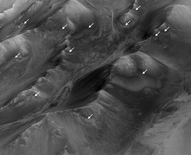 The white arrows indicate locations in this scene where numerous seasonal dark streaks, called "recurring slope lineae," have been identified in the Coprates Montes area of Mars' Valles Marineris by repeated observations from orbit. Image Credit: NASA/JPL-Caltech/Univ. of Arizona The white arrows indicate locations in this scene where numerous seasonal dark streaks, called "recurring slope lineae," have been identified in the Coprates Montes area of Mars' Valles Marineris by repeated observations from orbit. Image Credit: NASA/JPL-Caltech/Univ. of Arizona