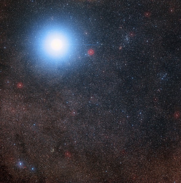 This image of the sky around the bright star Alpha Centauri AB also shows the much fainter red dwarf star, Proxima Centauri, the closest star to the Solar System. The picture was created from pictures forming part of the Digitized Sky Survey 2. The blue halo around Alpha Centauri AB is an artifact of the photographic process, the star is really pale yellow in colour like the Sun. Credit: Digitized Sky Survey 2 Acknowledgement: Davide De Martin/Mahdi Zamani This image of the sky around the bright star Alpha Centauri AB also shows the much fainter red dwarf star, Proxima Centauri, the closest star to the Solar System. The picture was created from pictures forming part of the Digitized Sky Survey 2. The blue halo around Alpha Centauri AB is an artifact of the photographic process, the star is really pale yellow in colour like the Sun. Credit: Digitized Sky Survey 2 Acknowledgement: Davide De Martin/Mahdi Zamani