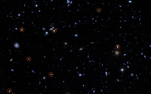 This image combines a background picture taken by the NASA/ESA Hubble Space Telescope (blue/green) with a new very deep ALMA view of this field (orange, marked with circles). All the objects that ALMA sees appear to be massive star-forming galaxies. This image is based on the ALMA survey by J. Dunlop and colleagues, covering the full HUDF area. Credit: ALMA (ESO/NAOJ/NRAO)/NASA/ESA/J. Dunlop et al. and S. Beckwith (STScI) and the HUDF Team. This image combines a background picture taken by the NASA/ESA Hubble Space Telescope (blue/green) with a new very deep ALMA view of this field (orange, marked with circles). All the objects that ALMA sees appear to be massive star-forming galaxies. This image is based on the ALMA survey by J. Dunlop and colleagues, covering the full HUDF area. Credit: ALMA (ESO/NAOJ/NRAO)/NASA/ESA/J. Dunlop et al. and S. Beckwith (STScI) and the HUDF Team.