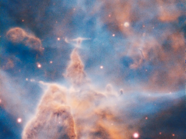 This craggy fantasy mountaintop enshrouded by wispy clouds looks like a bizarre landscape. But it is indeed a pillar of gas and dust, three light-years tall, which is being eaten away by the brilliant light from nearby bright stars. The pillar is also being assaulted from within, as infant stars buried inside it fire off jets of gas that can be seen streaming from towering peaks. Credit: ESO/A. McLeod This craggy fantasy mountaintop enshrouded by wispy clouds looks like a bizarre landscape. But it is indeed a pillar of gas and dust, three light-years tall, which is being eaten away by the brilliant light from nearby bright stars. The pillar is also being assaulted from within, as infant stars buried inside it fire off jets of gas that can be seen streaming from towering peaks. Credit: ESO/A. McLeod