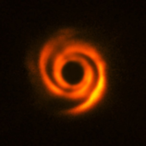 Using the ESO’s SPHERE instrument at the Very Large Telescope, a team of astronomer observed the planetary disc surrounding the star HD 135344B, about 450 light-years away. The disc shows prominent spiral arm-like structures. These are thought to have been created by one or multiple massive protoplanets, destined to become Jupiter-like worlds. The central part of the image appears dark because SPHERE blocks out the light from the brilliant central star to reveal the much fainter structures surrounding it. Credit: ESO, T. Stolker et al. Using the ESO’s SPHERE instrument at the Very Large Telescope, a team of astronomer observed the planetary disc surrounding the star HD 135344B, about 450 light-years away. The disc shows prominent spiral arm-like structures. These are thought to have been created by one or multiple massive protoplanets, destined to become Jupiter-like worlds. The central part of the image appears dark because SPHERE blocks out the light from the brilliant central star to reveal the much fainter structures surrounding it. Credit: ESO, T. Stolker et al.