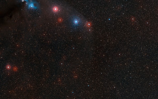This wide field image shows the sky around the very faint neutron star RX J1856.5-3754 in the southern constellation of Corona Australis. This part of the sky also contains interesting regions of dark and bright nebulosity surrounding the variable star R Coronae Australis (upper left), as well as the globular star cluster NGC 6723. The neutron star itself is too faint to be seen here, but lies very close to the centre of the image. Credit: ESO/Digitized Sky Survey 2 Acknowledgement: Davide De Martin This wide field image shows the sky around the very faint neutron star RX J1856.5-3754 in the southern constellation of Corona Australis. This part of the sky also contains interesting regions of dark and bright nebulosity surrounding the variable star R Coronae Australis (upper left), as well as the globular star cluster NGC 6723. The neutron star itself is too faint to be seen here, but lies very close to the centre of the image. Credit: ESO/Digitized Sky Survey 2 Acknowledgement: Davide De Martin