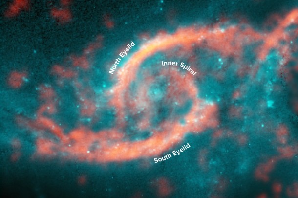 Annotated image showing dazzling eyelid-like features bursting with stars in galaxy IC 2163 formed from a tsunami of stars and gas triggered by a glancing collision with galaxy NGC 2207 (a portion of its spiral arm is shown on right side of image). ALMA image of carbon monoxide (orange), which revealed motion of the gas in these features, is shown on top of Hubble image (blue) of the galaxy. Credit: M. Kaufman; B. Saxton (NRAO/AUI/NSF); ALMA (ESO/NAOJ/NRAO); NASA/ESA Hubble Space Telescope Annotated image showing dazzling eyelid-like features bursting with stars in galaxy IC 2163 formed from a tsunami of stars and gas triggered by a glancing collision with galaxy NGC 2207 (a portion of its spiral arm is shown on right side of image). ALMA image of carbon monoxide (orange), which revealed motion of the gas in these features, is shown on top of Hubble image (blue) of the galaxy. Credit: M. Kaufman; B. Saxton (NRAO/AUI/NSF); ALMA (ESO/NAOJ/NRAO); NASA/ESA Hubble Space Telescope