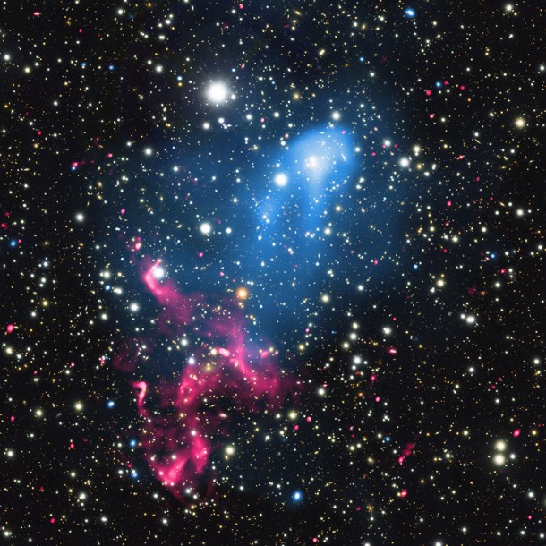 This composite image contains X-rays from Chandra (blue), radio emission from the GMRT (red), and optical data from Subaru (red, green, and blue) of the colliding galaxy clusters called Abell 3411 and Abell 3412. These and other telescopes were used to analyze how the combination of these two powerful phenomena can create an extraordinary cosmic particle accelerator. X-ray: NASA/CXC/SAO/R. van Weeren et al; Optical: NAOJ/Subaru; Radio: NCRA/TIFR/GMRT This composite image contains X-rays from Chandra (blue), radio emission from the GMRT (red), and optical data from Subaru (red, green, and blue) of the colliding galaxy clusters called Abell 3411 and Abell 3412. These and other telescopes were used to analyze how the combination of these two powerful phenomena can create an extraordinary cosmic particle accelerator. X-ray: NASA/CXC/SAO/R. van Weeren et al; Optical: NAOJ/Subaru; Radio: NCRA/TIFR/GMRT