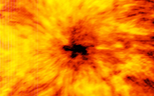 This ALMA image of an enormous sunspot was taken at a wavelength of 1.25 millimetres. Sunspots are transient features that occur in regions where the Sun’s magnetic field is extremely concentrated and powerful. They have lower temperatures than their surrounding regions, which is why they appear relatively dark. Credit: ALMA (ESO/NAOJ/NRAO) This ALMA image of an enormous sunspot was taken at a wavelength of 1.25 millimetres. Sunspots are transient features that occur in regions where the Sun’s magnetic field is extremely concentrated and powerful. They have lower temperatures than their surrounding regions, which is why they appear relatively dark. Credit: ALMA (ESO/NAOJ/NRAO)