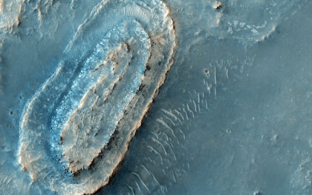 This image lies in the middle of a candidate landing site in the Northeast part of Syrtis Major, a huge shield volcano, and near the Northwest rim of Isidis Planitia, a giant impact basin. This image lies in the middle of a candidate landing site in the Northeast part of Syrtis Major, a huge shield volcano, and near the Northwest rim of Isidis Planitia, a giant impact basin.