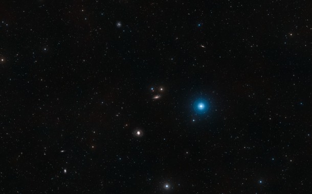 This rich wide-field view captures not only the edge-on galaxy NGC 1055 at the centre but also the bright galaxy NGC 1068 (also known as Messier 77, it is an active galaxy with a huge black hole at its centre) to its lower-left, the fainter galaxy NGC 1032 to the upper right and the barred spiral galaxy NGC 1073 to the upper left. In addition, much closer to home, the bright naked-eye blue star Delta Ceti appears at the right of centre. This picture was created from images in the Digitized Sky Survey 2. Credit: ESO/Digitized Sky Survey 2 Acknowledgement: Davide De Martin This rich wide-field view captures not only the edge-on galaxy NGC 1055 at the centre but also the bright galaxy NGC 1068 (also known as Messier 77, it is an active galaxy with a huge black hole at its centre) to its lower-left, the fainter galaxy NGC 1032 to the upper right and the barred spiral galaxy NGC 1073 to the upper left. In addition, much closer to home, the bright naked-eye blue star Delta Ceti appears at the right of centre. This picture was created from images in the Digitized Sky Survey 2. Credit: ESO/Digitized Sky Survey 2 Acknowledgement: Davide De Martin