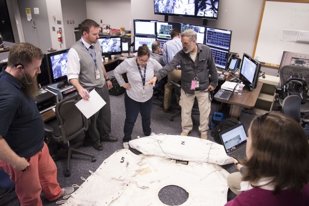 Mission support personnel in Houston work to come up with a plan to replace a lost thermal and micrometeoroid shield during a spacewalk. Credits: NASA/James Blair Mission support personnel in Houston work to come up with a plan to replace a lost thermal and micrometeoroid shield during a spacewalk. Credits: NASA/James Blair