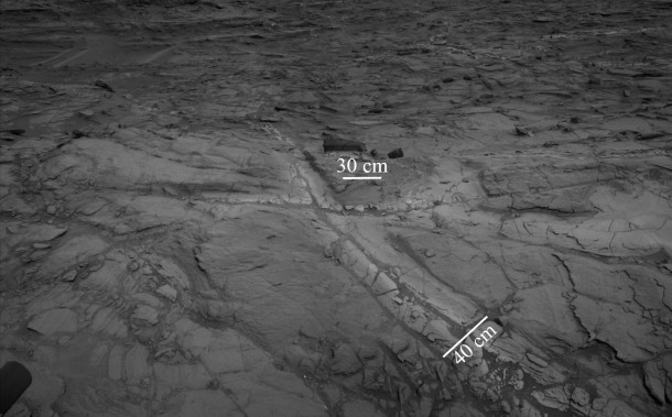 Pale zones called "halos" border bedrock fractures visible in this 2015 image from NASA's Curiosity Mars rover. Measurements overlaid on the image offer a sense of scale for the size of these fractures. The rover team determined that the halos are rich in silica, a clue to the duration of wet environmental conditions long ago. The location is on the lower slope of Mars' Mount Sharp. Image credit: NASA/JPL-Caltech Pale zones called "halos" border bedrock fractures visible in this 2015 image from NASA's Curiosity Mars rover. Measurements overlaid on the image offer a sense of scale for the size of these fractures. The rover team determined that the halos are rich in silica, a clue to the duration of wet environmental conditions long ago. The location is on the lower slope of Mars' Mount Sharp. Image credit: NASA/JPL-Caltech