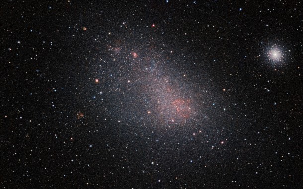As well as the SMC itself this very wide-field image reveals many background galaxies and several star clusters, including the very bright 47 Tucanae globular cluster at the right of the picture. Credit: ESO/VISTA VMC As well as the SMC itself this very wide-field image reveals many background galaxies and several star clusters, including the very bright 47 Tucanae globular cluster at the right of the picture. Credit: ESO/VISTA VMC