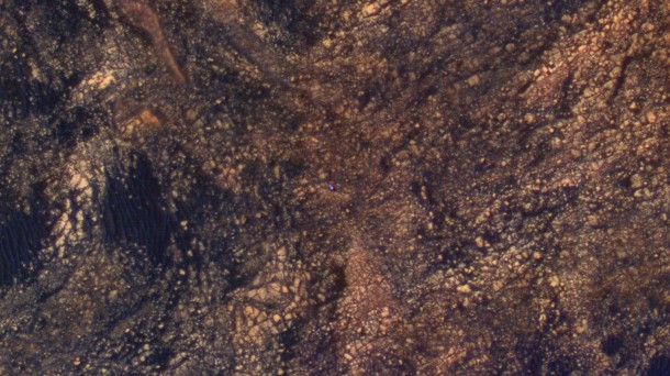 The feature that appears bright blue at the center of this scene is NASA's Curiosity Mars rover amid tan rocks and dark sand on Mount Sharp, as viewed by the HiRISE camera on NASA's Mars Reconnaissance Orbiter on June 5, 2017. Image Credit: NASA/JPL-Caltech/Univ. of Arizona The feature that appears bright blue at the center of this scene is NASA's Curiosity Mars rover amid tan rocks and dark sand on Mount Sharp, as viewed by the HiRISE camera on NASA's Mars Reconnaissance Orbiter on June 5, 2017. Image Credit: NASA/JPL-Caltech/Univ. of Arizona
