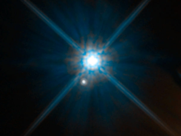 Looks can be deceiving. In this Hubble Space Telescope image, the white dwarf star Stein 2051 B and the smaller star below it appear to be close neighbors. The stars, however, reside far away from each other. Stein 2051 B is 17 light-years from Earth; the other star is about 5,000 light-years away. Credits: NASA, ESA, and K. Sahu (STScI) Looks can be deceiving. In this Hubble Space Telescope image, the white dwarf star Stein 2051 B and the smaller star below it appear to be close neighbors. The stars, however, reside far away from each other. Stein 2051 B is 17 light-years from Earth; the other star is about 5,000 light-years away. Credits: NASA, ESA, and K. Sahu (STScI)