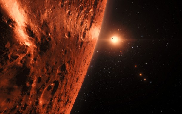 This artist’s impression shows the view from the surface of one of the planets in the TRAPPIST-1 system. At least seven planets orbit this ultracool dwarf star 40 light-years from Earth and they are all roughly the same size as the Earth. Several of the planets are at the right distances from their star for liquid water to exist on the surfaces. This artist’s impression is based on the known physical parameters of the planets and stars seen, and uses a vast database of objects in the Universe. Credit: ESO/N. Bartmann/spaceengine.org This artist’s impression shows the view from the surface of one of the planets in the TRAPPIST-1 system. At least seven planets orbit this ultracool dwarf star 40 light-years from Earth and they are all roughly the same size as the Earth. Several of the planets are at the right distances from their star for liquid water to exist on the surfaces. This artist’s impression is based on the known physical parameters of the planets and stars seen, and uses a vast database of objects in the Universe. Credit: ESO/N. Bartmann/spaceengine.org