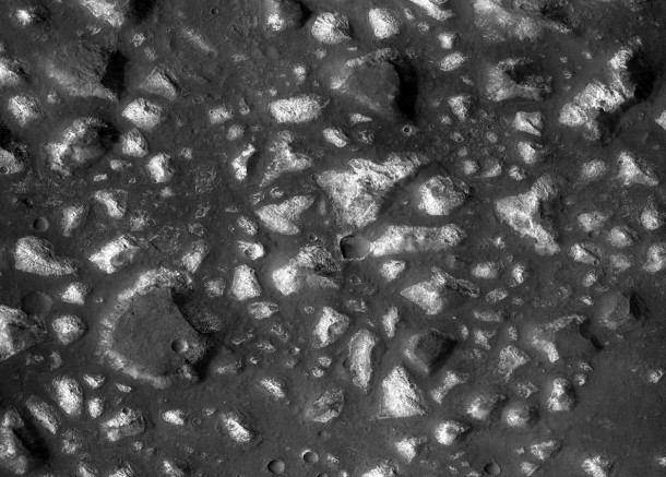This view of a portion of the Eridania region of Mars shows blocks of deep-basin deposits that have been surrounded and partially buried by younger volcanic deposits. Image credit: NASA/JPL-Caltech/MSSS This view of a portion of the Eridania region of Mars shows blocks of deep-basin deposits that have been surrounded and partially buried by younger volcanic deposits. Image credit: NASA/JPL-Caltech/MSSS