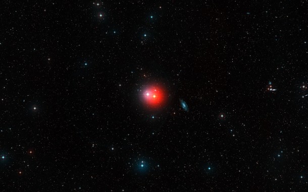 This colourful image shows the sky around the bright pair of stars π1 Gruis (centre-right, very red) and π2 Gruis (centre-left, bluish-white). Just right of centre the bright spiral galaxy IC 5201 is also visible and many other fainter galaxies are scattered across this wide-field image from the Digitized Sky Survey 2. Credit: ESO/Digitized Sky Survey 2. Acknowledgement: Davide De Martin This colourful image shows the sky around the bright pair of stars π1 Gruis (centre-right, very red) and π2 Gruis (centre-left, bluish-white). Just right of centre the bright spiral galaxy IC 5201 is also visible and many other fainter galaxies are scattered across this wide-field image from the Digitized Sky Survey 2. Credit: ESO/Digitized Sky Survey 2. Acknowledgement: Davide De Martin
