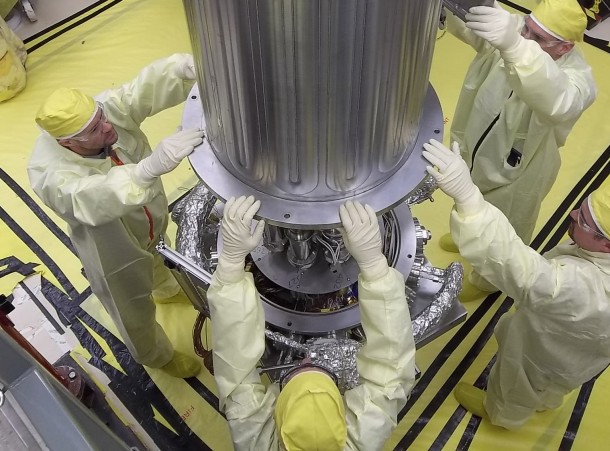 NASA and NNSA engineers lower the wall of the vacuum chamber around the Kilowatt Reactor Using Stirling TechnologY (KRUSTY system). The vacuum chamber is later evacuated to simulate the conditions of space when KRUSTY operates. Credits: Los Alamos National Laboratory NASA and NNSA engineers lower the wall of the vacuum chamber around the Kilowatt Reactor Using Stirling TechnologY (KRUSTY system). The vacuum chamber is later evacuated to simulate the conditions of space when KRUSTY operates. Credits: Los Alamos National Laboratory