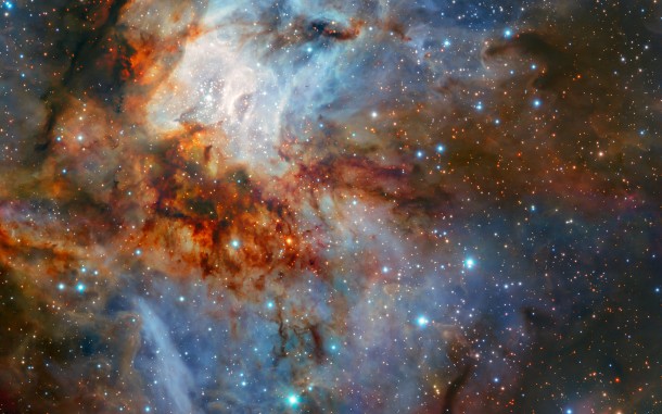 New observations with ESO’s Very Large Telescope show the star cluster RCW 38 in all its glory. This image was taken during testing of the HAWK-I camera with the GRAAL adaptive optics system. It shows the cluster and its surrounding clouds of brightly glowing gas in exquisite detail, with dark tendrils of dust threading through the bright core of this young gathering of stars. Credit: ESO/K. Muzic New observations with ESO’s Very Large Telescope show the star cluster RCW 38 in all its glory. This image was taken during testing of the HAWK-I camera with the GRAAL adaptive optics system. It shows the cluster and its surrounding clouds of brightly glowing gas in exquisite detail, with dark tendrils of dust threading through the bright core of this young gathering of stars. Credit: ESO/K. Muzic