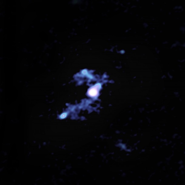 This image, created using radio data from the Atacama Large Millimeter/submillimeter Array (ALMA), shows W2246-0526 as it syphons material away from three smaller galaxies. W2246-0526 and one of its companions are in the center; the second galaxy is above them; the third is to the lower left. Image Credit: ALMA (ESO/NAOJ/NRAO); S. Dagnello (NRAO/AUI/NSF) This image, created using radio data from the Atacama Large Millimeter/submillimeter Array (ALMA), shows W2246-0526 as it syphons material away from three smaller galaxies. W2246-0526 and one of its companions are in the center; the second galaxy is above them; the third is to the lower left. Image Credit: ALMA (ESO/NAOJ/NRAO); S. Dagnello (NRAO/AUI/NSF)