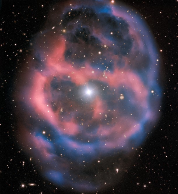 The faint, ephemeral glow emanating from the planetary nebula ESO 577-24 persists for only a short time — around 10,000 years, a blink of an eye in astronomical terms. ESO’s Very Large Telescope captured this shell of glowing ionised gas — the last breath of the dying star whose simmering remains are visible at the heart of this image. As the gaseous shell of this planetary nebula expands and grows dimmer, it will slowly disappear from sight. Credit: ESO The faint, ephemeral glow emanating from the planetary nebula ESO 577-24 persists for only a short time — around 10,000 years, a blink of an eye in astronomical terms. ESO’s Very Large Telescope captured this shell of glowing ionised gas — the last breath of the dying star whose simmering remains are visible at the heart of this image. As the gaseous shell of this planetary nebula expands and grows dimmer, it will slowly disappear from sight. Credit: ESO